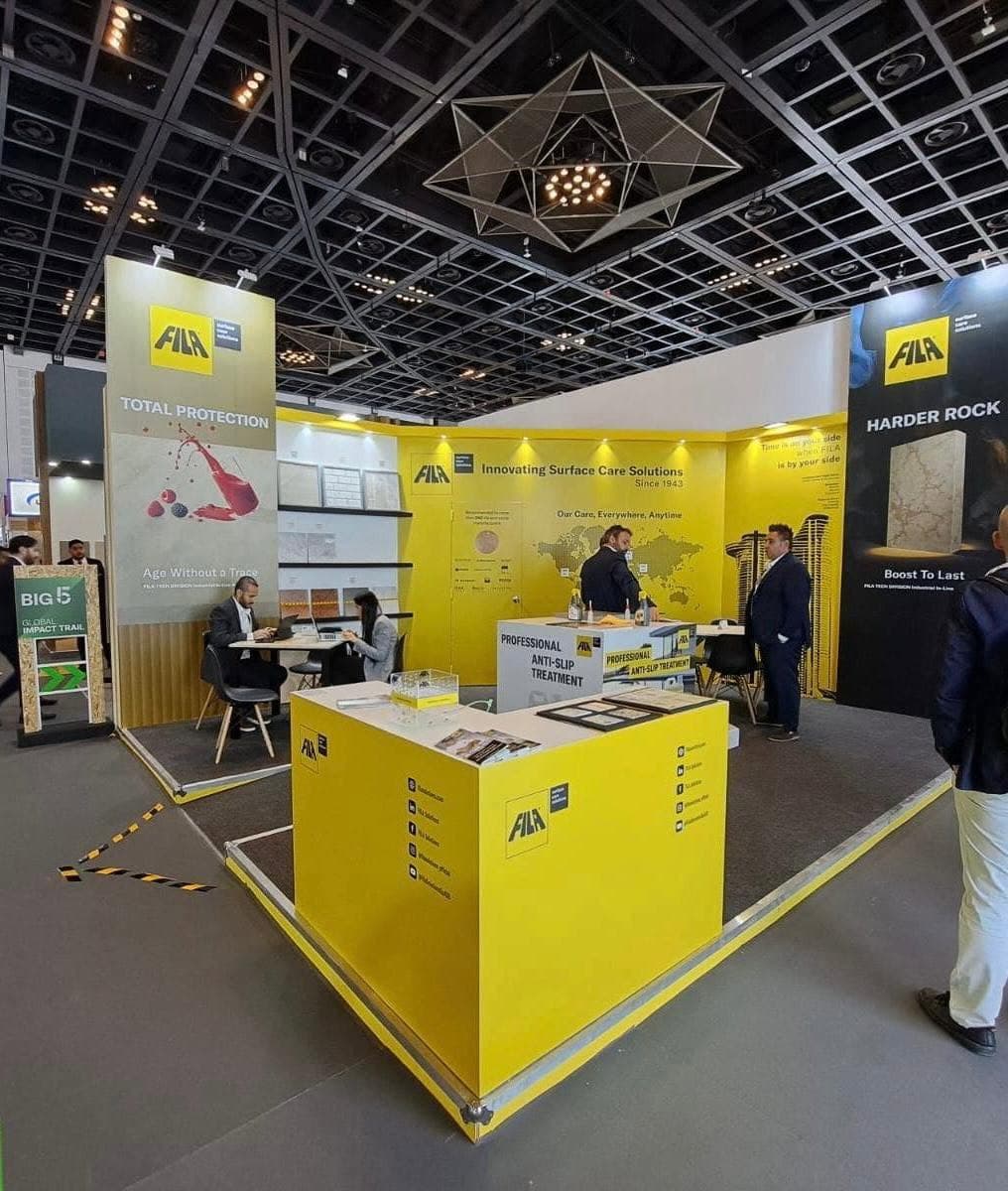 FILA surface-care stand at Big 5, a yellow island counter between tall product-graphic towers