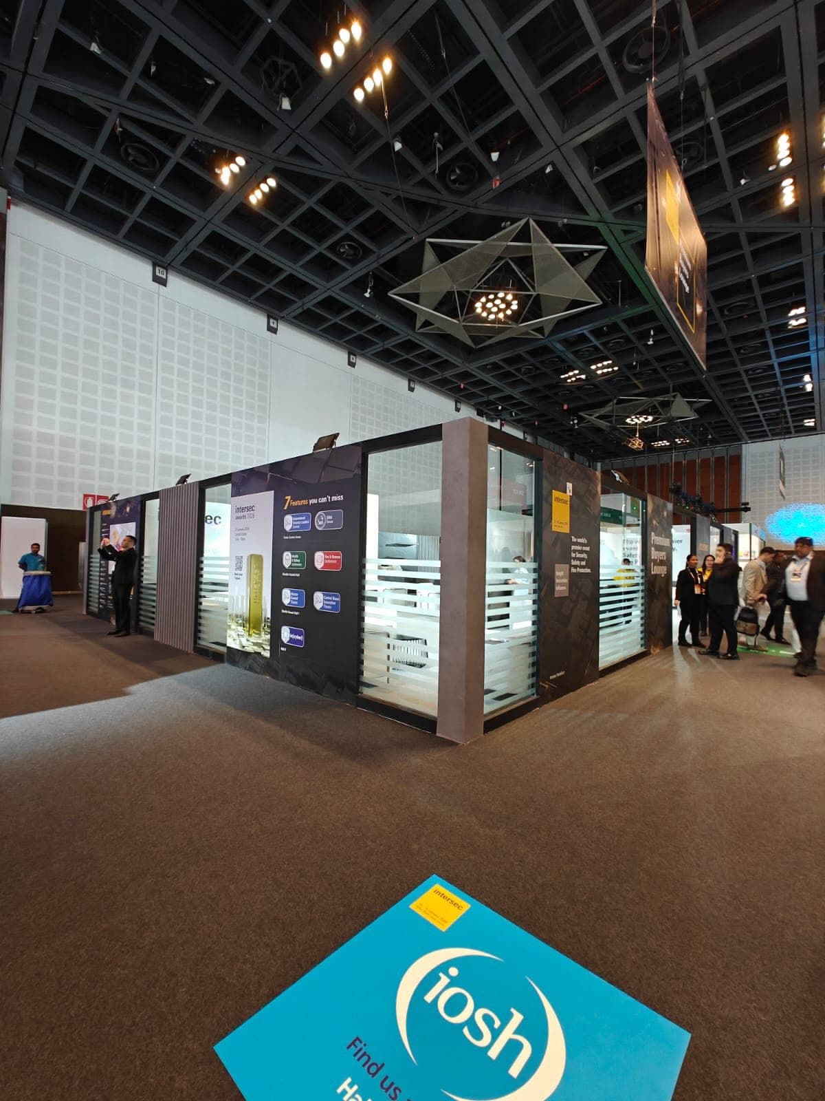 Intersec Premium Buyers Lounge, a run of glazed meeting rooms with fritted privacy bands under a coffered ceiling