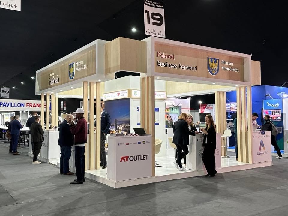 Poland Business Forward pavilion for the Silesian Voivodeship, a timber-batten portal over exhibitor counters