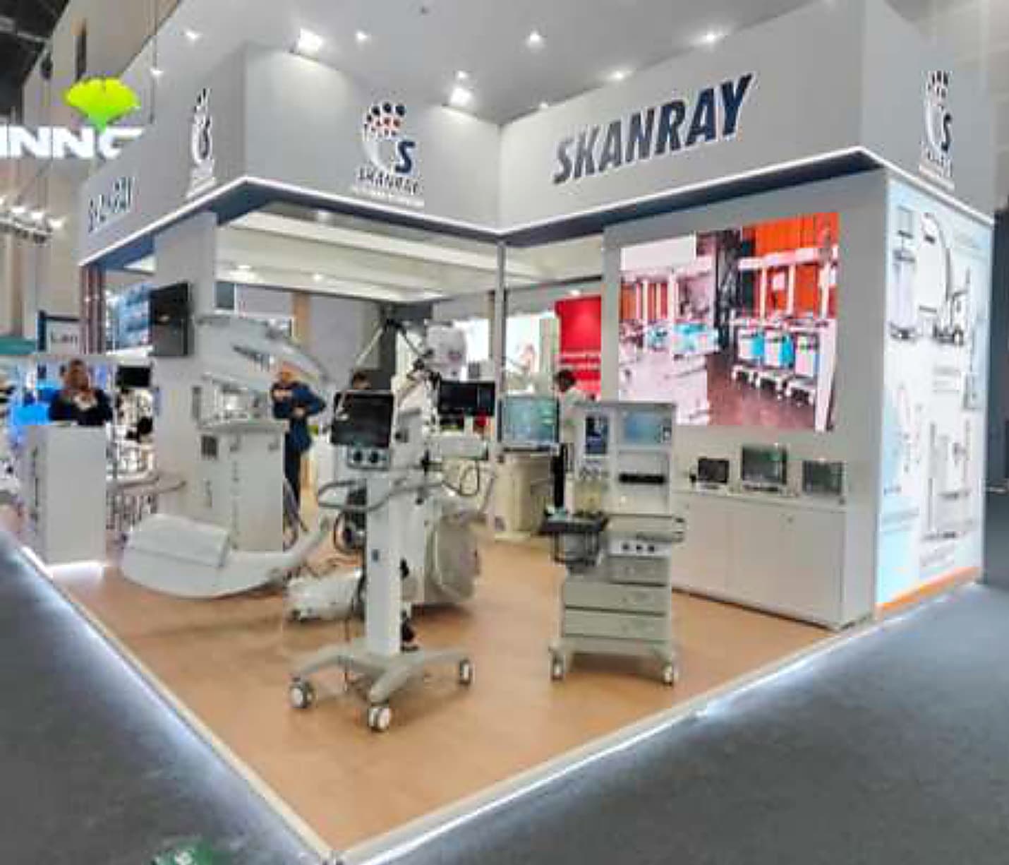 Medical imaging stand with anaesthesia and surgical equipment displayed on an open timber floor