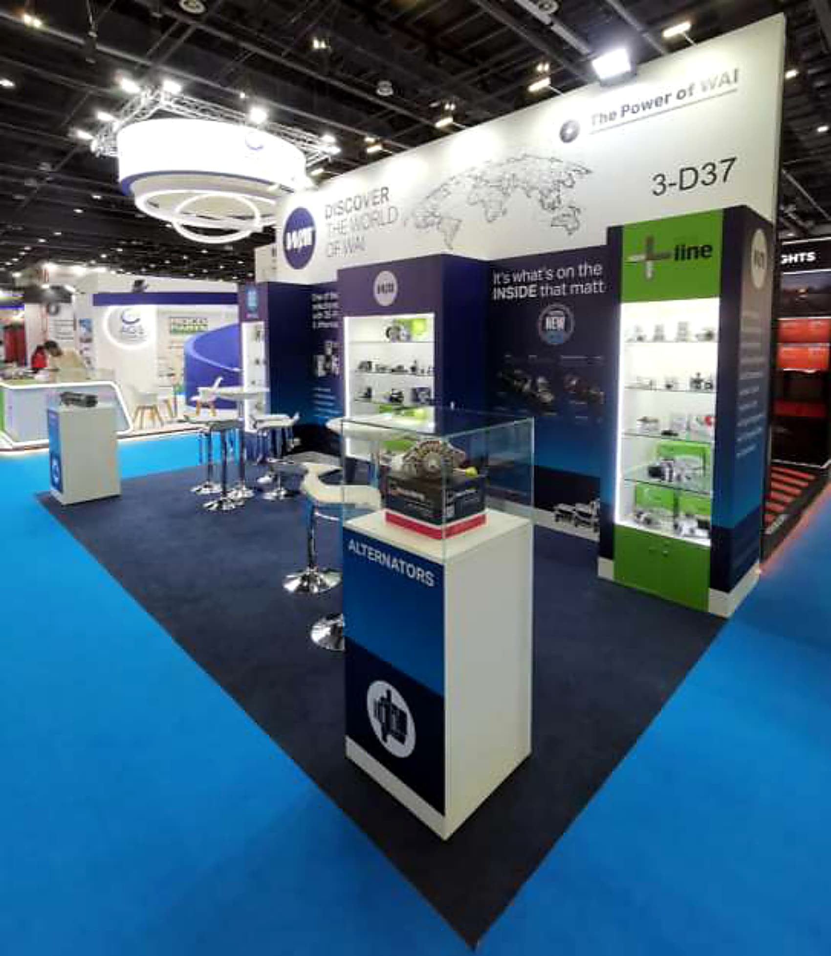 Automotive parts stand with lit product vitrines and a circular halo light rig overhead